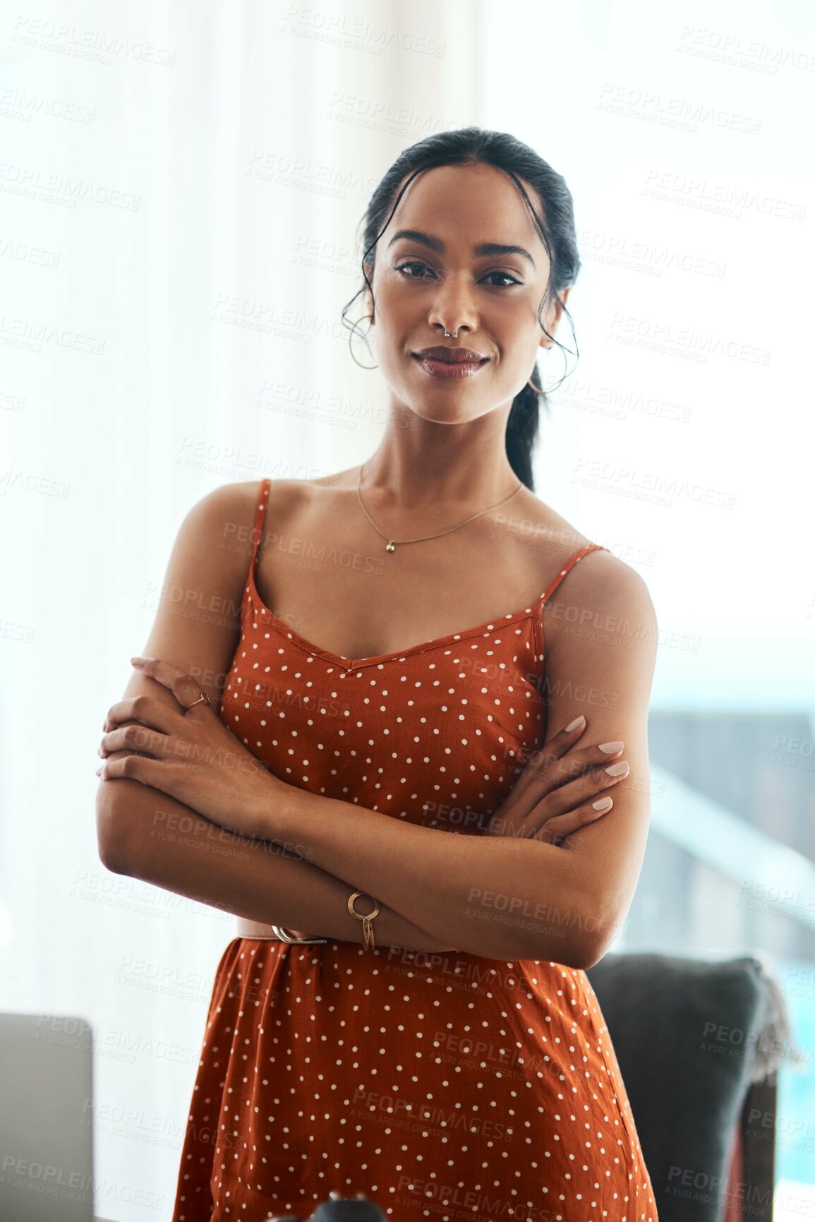 Buy stock photo Cropped portrait of an attractive young businesswoman standing with her arms crossed in her home office