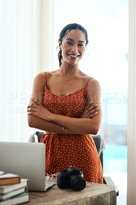 Buy stock photo Cropped portrait of an attractive young businesswoman standing with her arms crossed in her home office