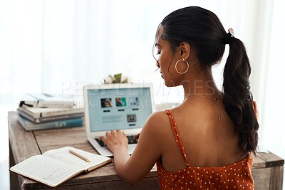 Buy stock photo Cropped shot of an unrecognizable businesswoman sitting alone in her home office and blogging from her laptop