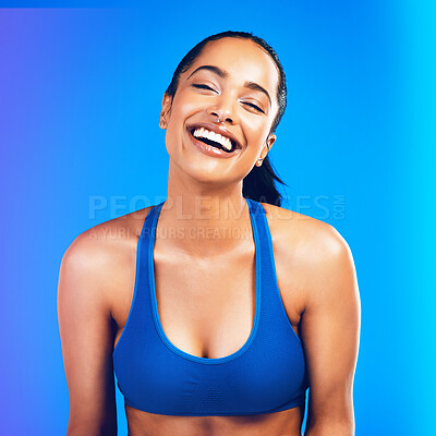 Buy stock photo Studio portrait of an attractive young sportswoman posing against a blue background