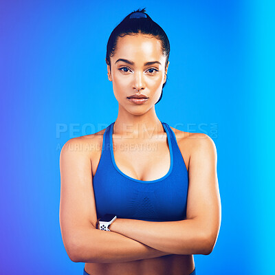Buy stock photo Studio portrait of an attractive young sportswoman posing against a blue background