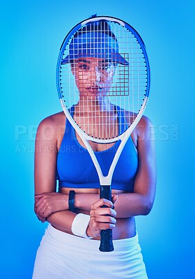 Buy stock photo Cropped portrait of an attractive young female tennis player posing against a blue background