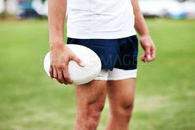 Buy stock photo Cropped shot of an unrecognisable man holding a rugby ball during a game