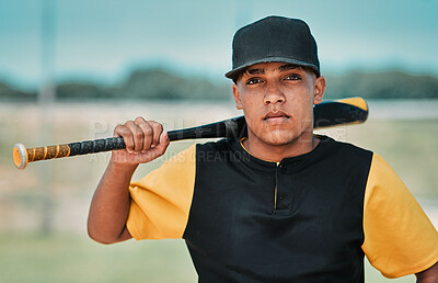 Buy stock photo Shot of a young baseball player holding a baseball bat while posing outside on the pitch