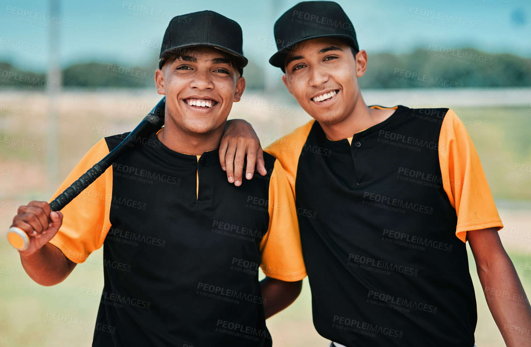 Buy stock photo Portrait of two young baseball players standing together on the pitch