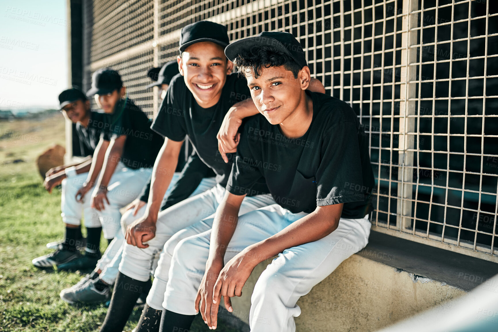 Buy stock photo Shot of a group of baseball players sitting together on a field