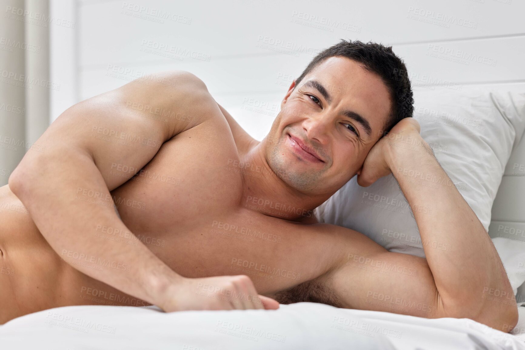 Buy stock photo Shot of a handsome young man lying in bed