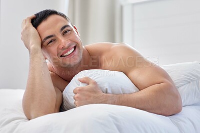 Buy stock photo Shot of a handsome young man lying in bed