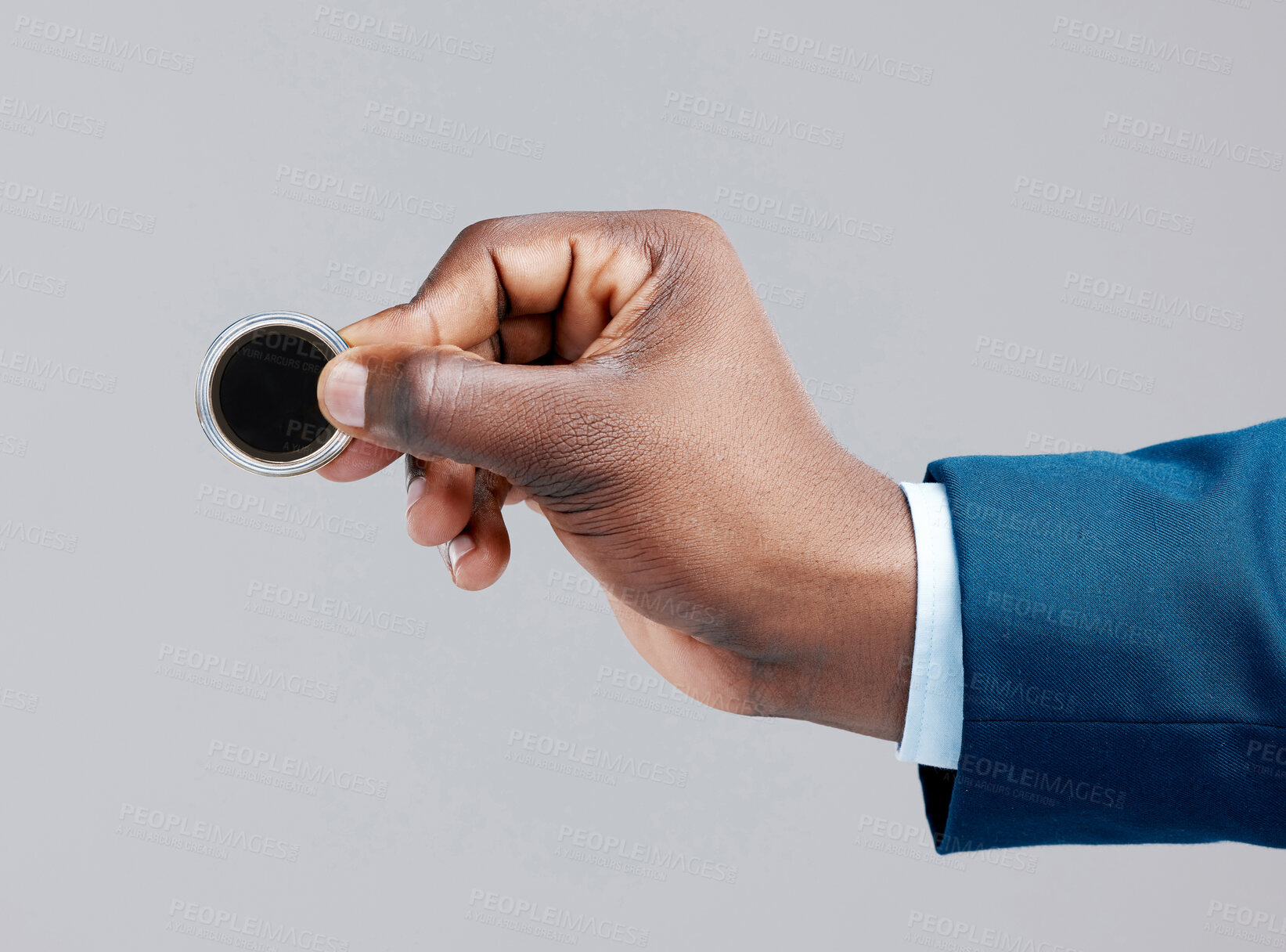 Buy stock photo Studio shot of a businessman holding a bitcoin against a grey background