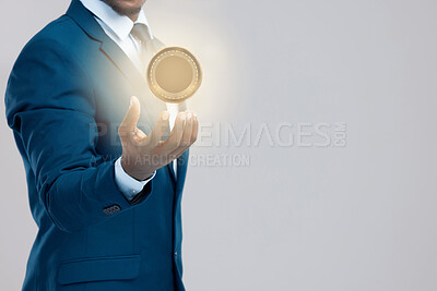 Buy stock photo Studio shot of a businessman holding a bitcoin against a grey background