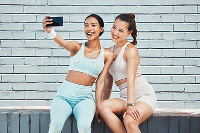 Buy stock photo Fitness friends, happy and phone selfie for social media picture, influencer content and workout after exercise by brick wall. Fit athlete females smile for wellness, fun and motivation for internet
