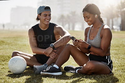 Buy stock photo Phone, fitness and soccer friends on field check training results app, watch mobile goal or social network football update. Sports, athlete or exercise couple on 5g smartphone for outdoor health chat