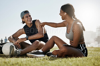 Buy stock photo Fitness, friends and soccer grass break by man and woman relax, laugh and enjoy conversation on a soccer field. Wellness, couple and cheerful interracial lady and guy bonding after football training