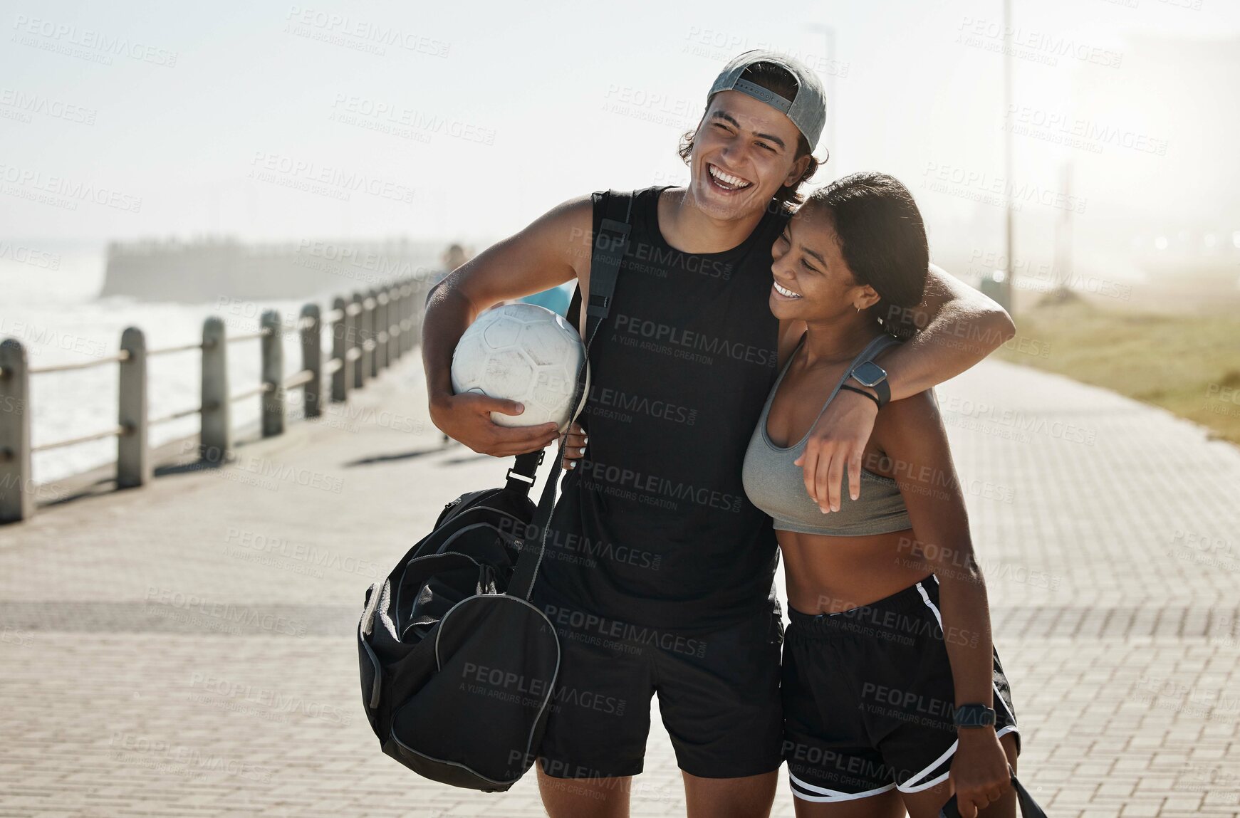 Buy stock photo Couple, sport and fitness, soccer and soccer ball by beach together after training and workout. Young man hug black woman, exercise outdoor and sports motivation, athlete with active lifestyle.