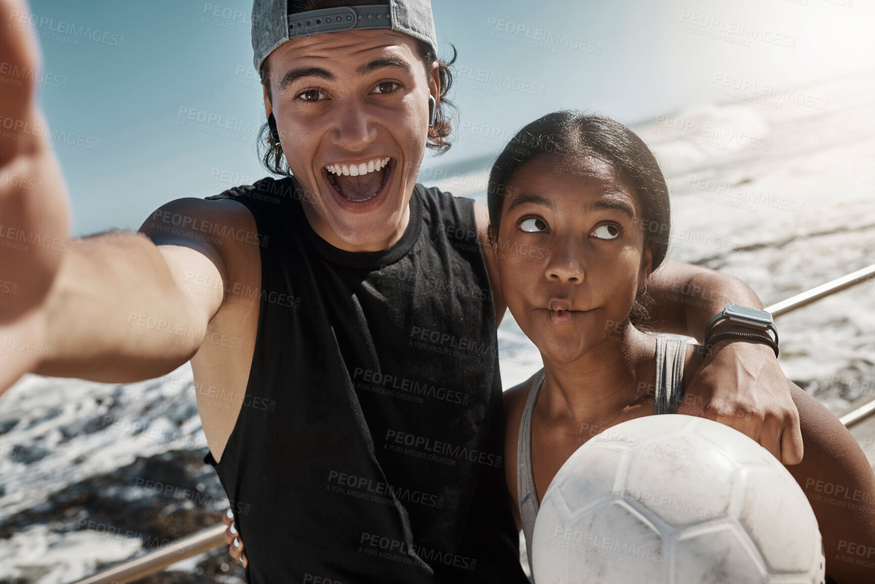 Buy stock photo Soccer ball, couple and fun sports selfie by beach, sea or ocean after fitness, workout and training. Portrait, smile and happy man and comic woman in photograph pov after football exercise in Brazil