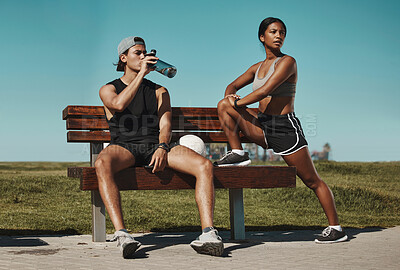 Buy stock photo Sports, bench and fitness people with water bottle in a park for outdoor training, workout or wellness with blue sky mock up. Athlete or runner couple relax together after running with summer mockup