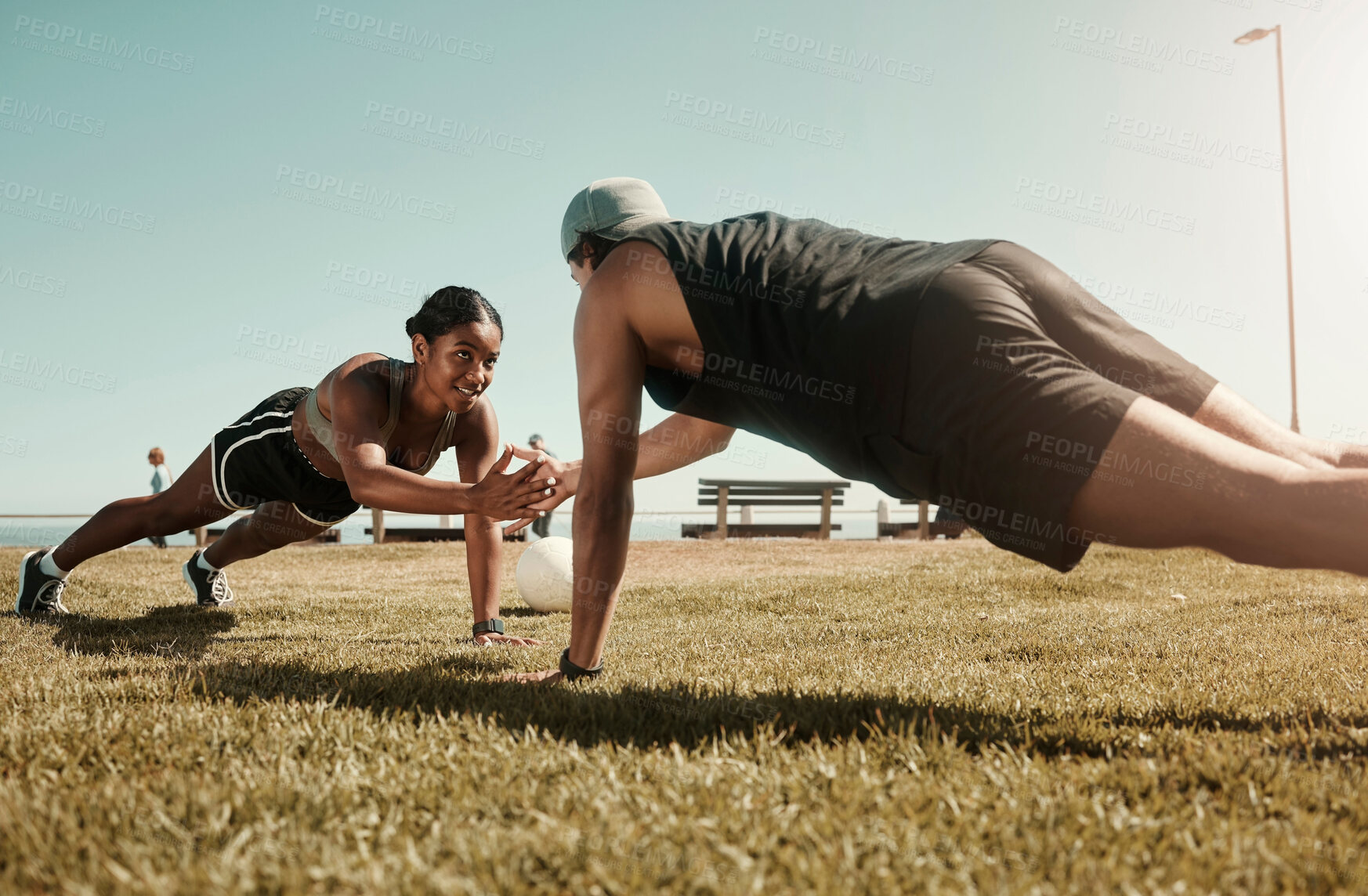 Buy stock photo Fitness, couple and support in plank and balance training during fitness, workout and exercise on a field. Sport, strong and fit athletes helping with motivation wellness challenge on grass field
