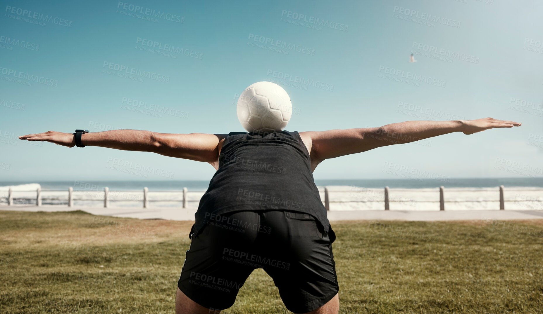 Buy stock photo Soccer ball, balance back and sports training of a man athlete at the beach for a workout. Exercise, fitness and health cardio of a person on a field by sea water, ocean and nature in summer