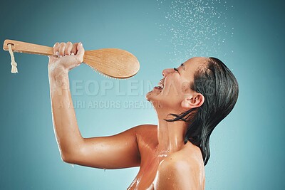 Buy stock photo Music, skincare and woman singing in shower and cleaning for wellness, health and beauty splash on blue background. Karaoke, bathroom and water splash with asian girl relax, washing and studio fun