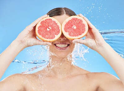 Buy stock photo Grapefruit, portrait and woman in studio face, water splash and wellness promotion for skincare, detox and shower. Beauty model cover eyes with vitamin c fruits or healthy food on eyes for nutrition