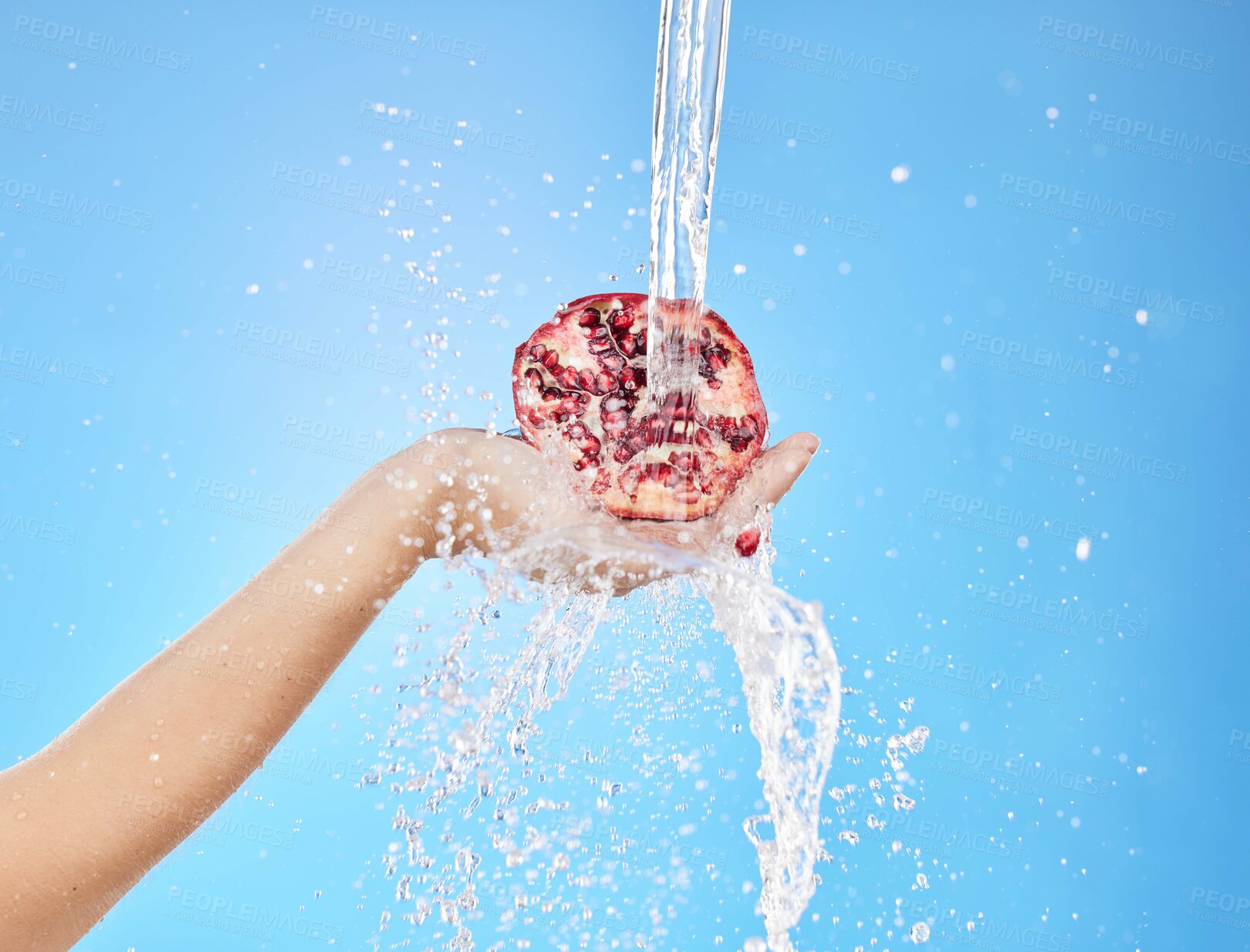 Buy stock photo Water, splash and pomegranate with hands of woman for health, antioxidant and nutrition. Summer, organic and fruit with girl model for vitamin c for diet, food and clean detox in blue background 