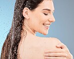 Water, body shower and happy woman on studio blue background for healthy skincare, beauty and personal hygiene. Young model, water splash and washing for wellness, cosmetics and cleaning in bathroom