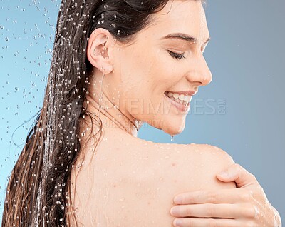 Buy stock photo Water, body shower and happy woman on studio blue background for healthy skincare, beauty and personal hygiene. Young model, water splash and washing for wellness, cosmetics and cleaning in bathroom