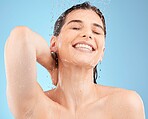 Water, skincare and beauty with woman in shower for cleaning, cosmetics and luxury. Self care, hygiene and hydration with girl model washing for health, wellness and relax in blue background studio