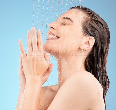 Buy stock photo Happy, woman, and shower in studio for hair, skincare and grooming on blue background mockup. Girl, water splash and relax in a bathroom for skin, hair care and cleaning, wellness and beauty mock up