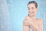 Cleaning, shower and woman with water in studio on blue background for beauty, wellness and body care. Spa hydration, skincare and happy girl washing for self care, health and hygiene in water drops