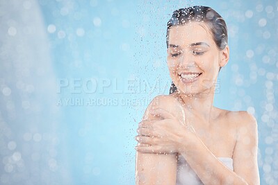 Buy stock photo Cleaning, shower and woman with water in studio on blue background for beauty, wellness and body care. Spa hydration, skincare and happy girl washing for self care, health and hygiene in water drops