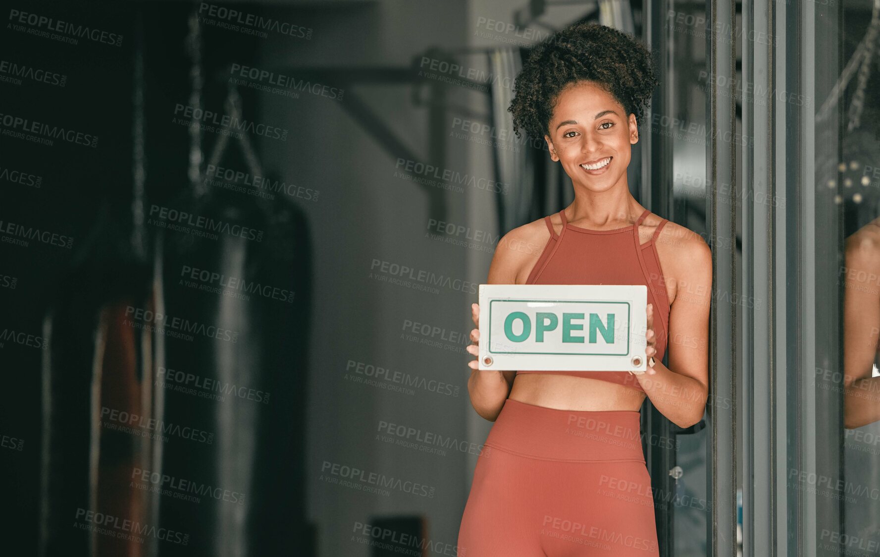 Buy stock photo Fitness, portrait or personal trainer at gym with an open sign for workout exercises or training. Manager, happy or healthy black woman with a friendly smile holding a board to welcome exercising