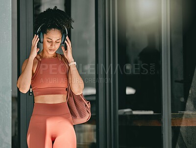 Buy stock photo Fitness, walking and black woman listen to music, relax podcast or radio for calm, stress relief or wellness mockup. Headphones, leaving gym and mock up girl on travel after training workout exercise