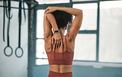 Buy stock photo Fitness, back view or black woman in gym stretching to warm up body or relax arm muscles in workout exercise. Wellness, flexible or healthy sports girl training or exercising with focus or motivation