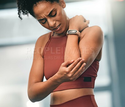 Buy stock photo Elbow, pain and fitness with a sports black woman in the gym with a sore joint from an exercise workout. Injury, training and health with a young female athlete struggling with a hurt arm or muscle