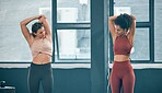 Teamwork, stretching and friends with women in gym for training, workout and exercise. Fitness, health and personal trainer with girl and muscle warm up for wellness, sports and progress goals