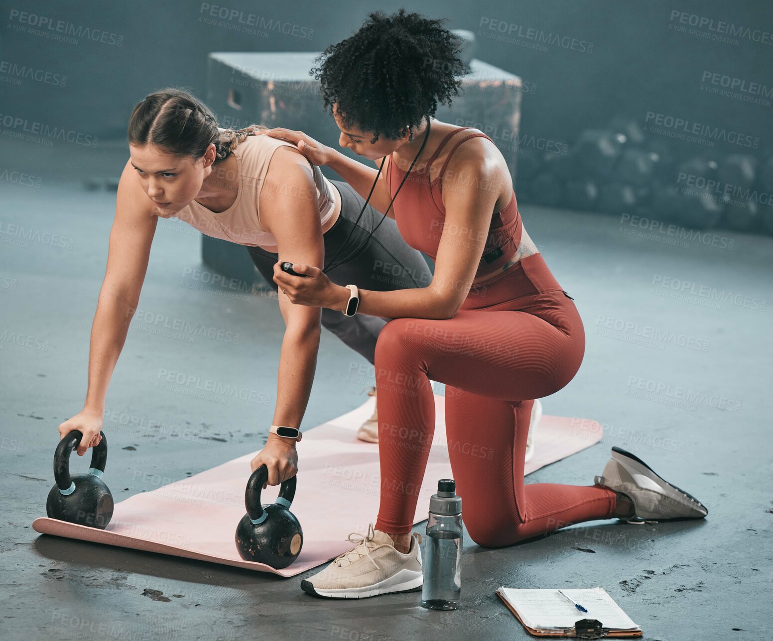 Buy stock photo Personal trainer, stopwatch and fitness with a woman athlete lifting weights during a plank in the gym for a workout. Coach, time and exercise with a female training using kettle bell equipment