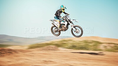 Buy stock photo Motorcycle, offroad driving and air jump in desert, blue sky and freedom. Driver, cycling and power stunt on dirt track, competition and motorbike performance on adventure course for fast action show