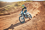 Sport, motorcycle and person driving in a desert for fitness, training and extreme sports in nature. Biking, motorbike and athletic practice stunt, speed and adrenaline in sand, exercise and freedom