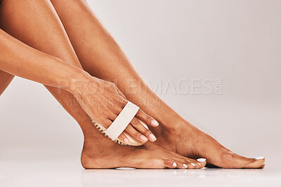Buy stock photo Woman, hands and foot scrub in skincare beauty, cosmetics or hygiene against gray studio background. Hand of female cleaning feet with exfoliation brush for soft skin, wellness or self love on mockup