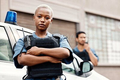 Buy stock photo Black woman, police and arms crossed in city for law enforcement protection or street safety. Portrait of serious African female person, security guard or cop ready for justice or crime in urban town