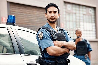 Buy stock photo Asian man, police and arms crossed in city for law enforcement, protection or street safety. Portrait of serious male person, security guard or cop ready for justice or crime on patrol in urban town