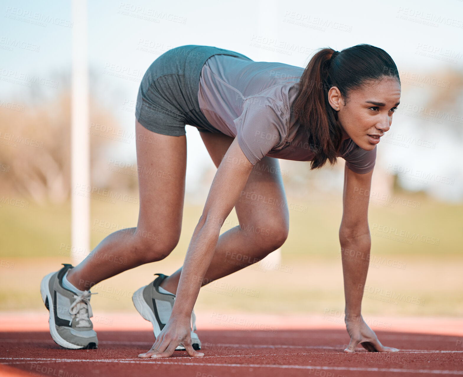 Buy stock photo Woman, fitness and running start in athletics, motivation or competition on stadium or track. Active female person or runner ready in sprint marathon, cardio workout or outdoor performance