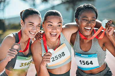 Happy women, award and celebration in winning, running or competition together on stadium track. Group of athletic people smile in happiness, medal or victory in sports marathon or success