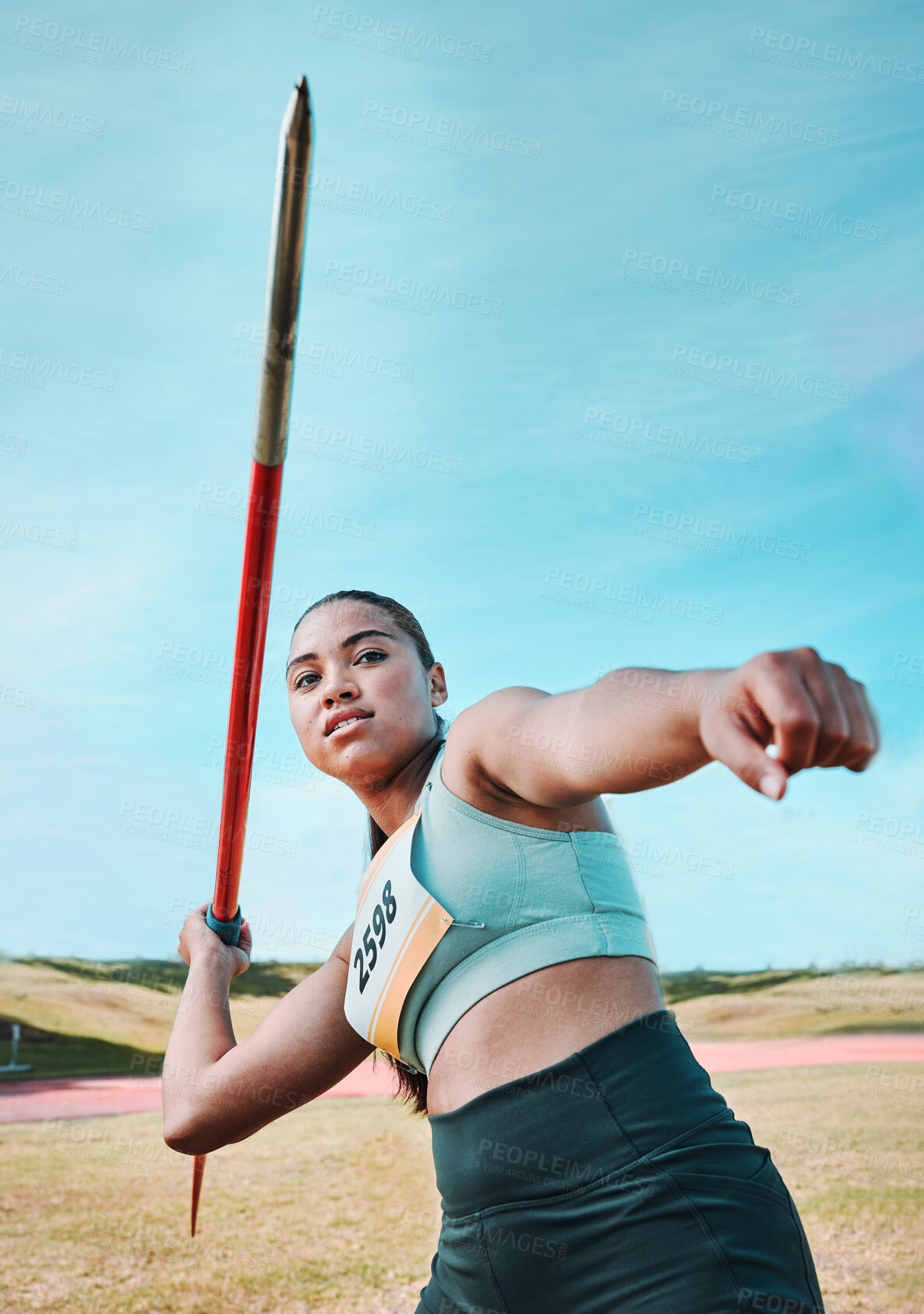 Buy stock photo Woman, javelin and athlete in competition, practice or sports training in fitness on stadium field. Active female person or athletic competitor throwing spear, poll or stick in distance