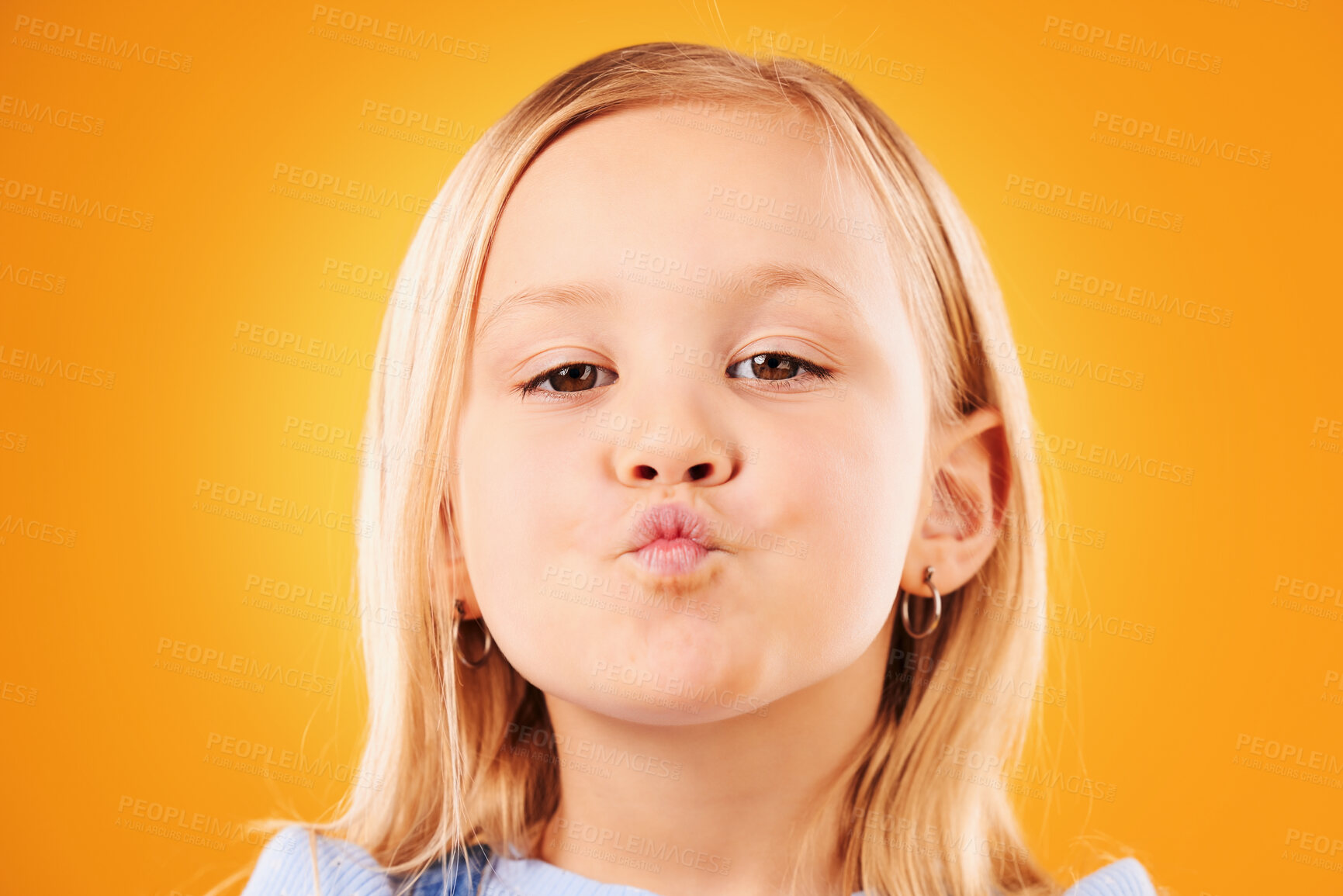 Buy stock photo Portrait, kiss and girl child in studio with love, expression or gesture against an orange background space. Faces, kisses and kid with emoji facial expression for fun, personality or cute affection