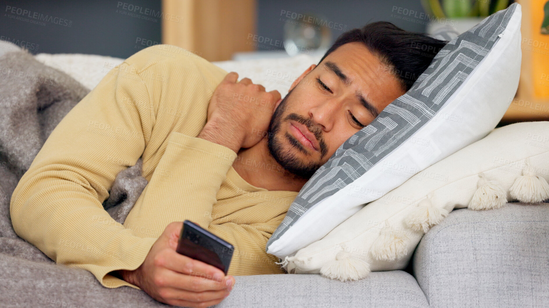 Buy stock photo Man, phone and blanket on sofa in home living room, tired and web chat with email notification. Guy, smartphone and sick with research for health, medicine and watch video on social media in house