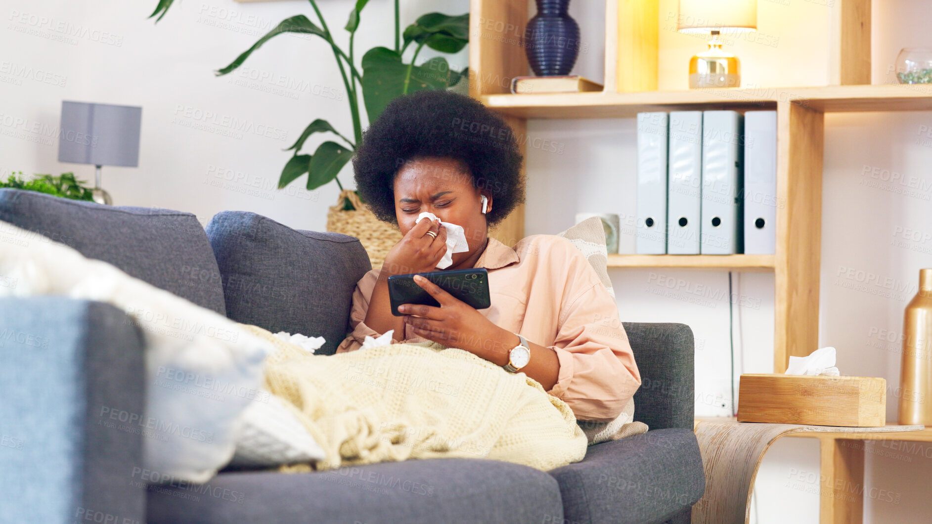 Buy stock photo Sick, couch and woman streaming with phone while coughing, sneeze and with fatigue and blowing nose. Living room, medical and person relax watching movies ill with cold, tissue or flu allergies