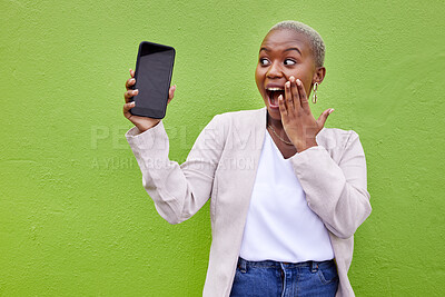 Buy stock photo Surprise, woman and phone screen with mockup by a wall or green background with wow advertising. Shocked African person or winner with a smartphone for social media, mobile app chat or website space