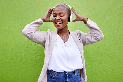 Buy stock photo Music, headphones and black woman dance on green wall background mockup space. Radio, singing and happy African person streaming podcast, hearing audio or listening to sound of jazz media for freedom